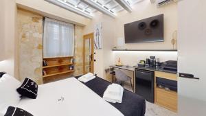 a room with a bed and a kitchen with a counter at Domus Vivendi in Chania