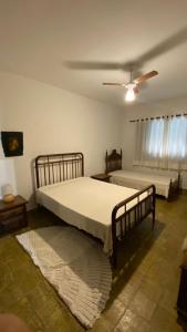 En eller flere senge i et værelse på Fazenda Villino Pistilli