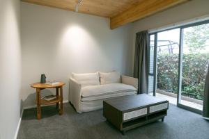 a living room with a couch and a table at Taradale Gem in Napier
