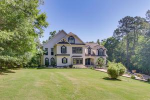 a large white house with a large yard at Dock and Home Theater Pet-Friendly Lake Wylie Home in Fort Mill