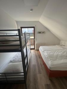 a room with two bunk beds and a window at Bear Apartment am Skihang in Winterberg
