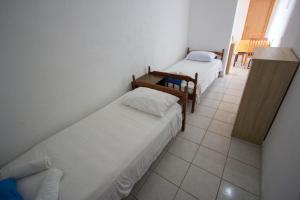 a room with two beds and a tiled floor at Apartment Rapak 12779e in Gdinj