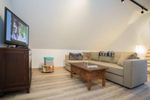 a living room with a couch and a coffee table at Bear Apartment am Skihang in Winterberg