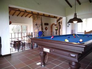 a pool table in the middle of a room at Casa frente al lago - Toca, Boyacá 