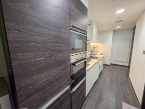 a kitchen with a large refrigerator and a counter at Sea View Studio Perfect for Couples In Harbour Row in Manama