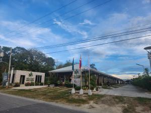 a building with two flags in front of it at Solano Hotel & Resort Rosario 