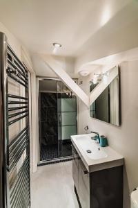 a bathroom with a sink and a mirror and a shower at Les Demeures de Castellane in Marseille +31 photos