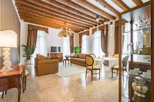 a living room with a couch and a table at San Teodoro Palace - Luxury Apartments in Venice
