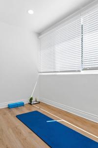 a room with a blue yoga mat on the floor at KING Size Bed in Cozy, Modern Hollywood Place in Los Angeles