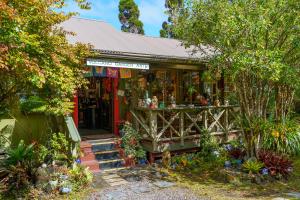 a garden shop with a lot of plants in it at Volcano Artist Cottage in Volcano +5 photos