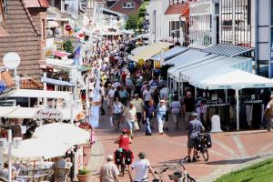 a crowd of people walking down a busy street at Reihenhaus Land and Sea in Büsum in Büsum