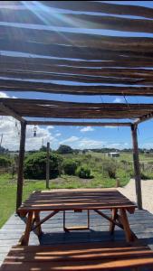 a wooden picnic table sitting on a wooden deck at Lalau Casa de Playa in Chapadmalal