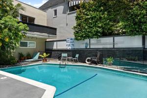 a swimming pool in front of a house at KING Size Bed in Cozy, Modern Hollywood Place in Los Angeles