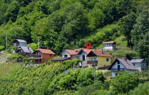 a group of houses on the side of a hill at 1 Bedroom Cozy Home In Remetinec in Remetinec