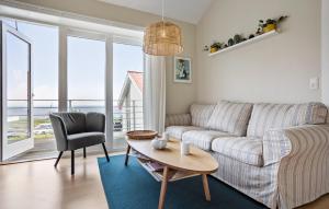 a living room with a couch and a table at 2 Bedroom Awesome Home In Gudhjem in Gudhjem