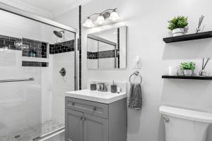 a white bathroom with a sink and a shower at KING Size Bed in Cozy, Modern Hollywood Place in Los Angeles +15 photos