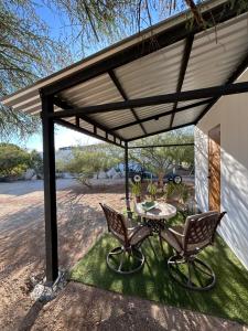 a patio with a table and chairs under awning at Casita Palo Verde in San José del Cabo