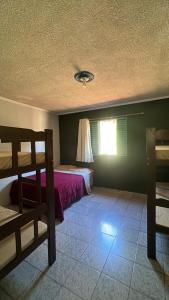 a bedroom with a bed and a window at Chácara Deus Proverá in Socorro +12 photos