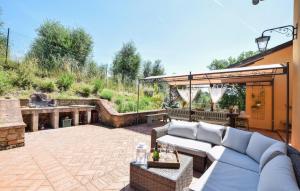 an outdoor patio with a couch and a grill at Pet Friendly Home In Monte San Savino in Monte San Savino