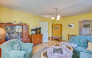 a living room with two chairs and a table at Wohnung Nordwestuckermark in Schmachtenhagen