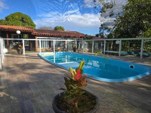 a swimming pool in front of a house at Quinta das Palmeiras Area 2 in Montes Claros +44 photos