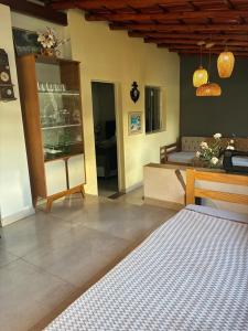 a living room with a bed and a table at Quinta das Palmeiras Area 2 in Montes Claros