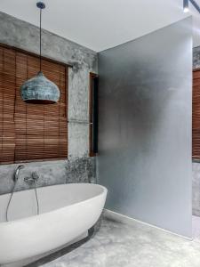 a bathroom with a white tub in a room at SooBali Niscala Villa 5 Bedroom in Canggu