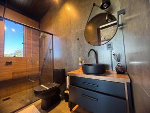 a bathroom with a sink and a toilet and a shower at Cabanas Mirante do Cerrado1 in Brasília +34 photos