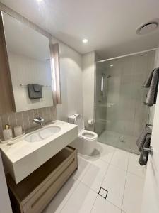 un bagno con lavandino, WC e doccia di Queens wharf Elegant High-Rise Living a Brisbane
