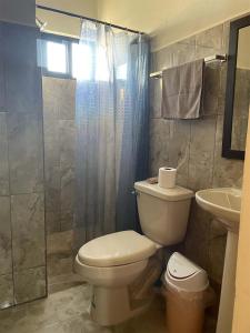 a bathroom with a toilet and a sink at Depa Pakabtun 2 hab wifi in Mérida