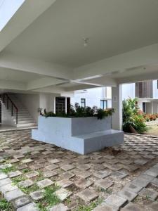 a white house with a planter on a patio at Almond Drive Talisay in Tangke