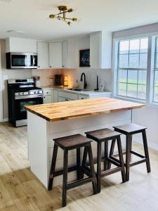 una cucina con piano in legno e 2 sgabelli di Charming & Luxe Cottage 3 BR 2 BA a Nederland