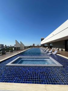 a swimming pool on the roof of a building at Dpto Home Office - Smart - Piscina - Cowork - Gym in Santa Cruz de la Sierra