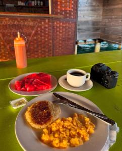 a table with a plate of food and a cup of coffee at Private Cabin on Aroma Island in Panama City