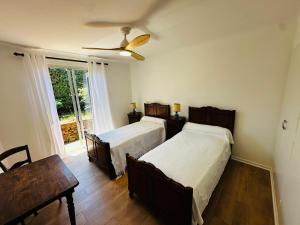 a bedroom with two beds and a ceiling fan at Charmante maison sécurisée avec piscine à Collioure - FR-1-309-454 in Collioure