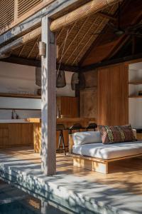 a room with a bed and a swimming pool at Villa Kokomo in Nusa Lembongan