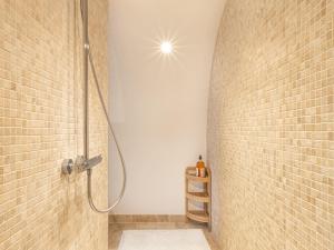 a shower in a bathroom with a brick wall at Maison rénovée au bord de l'Ognon avec grand jardin et plage privée - FR-1-583-395 in Cenans +27 photos