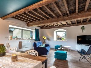 a living room with a couch and a table at Maison rénovée au bord de l'Ognon avec grand jardin et plage privée - FR-1-583-395 in Cenans