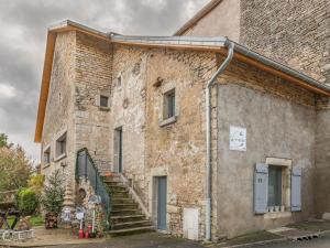 an old brick building with stairs on the side at Maison rénovée au bord de l'Ognon avec grand jardin et plage privée - FR-1-583-395 in Cenans