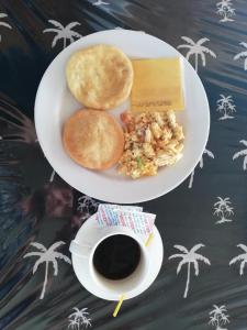 a plate of food and a cup of coffee at Romantic Cabin on Diablo Island San Blas in Panama City