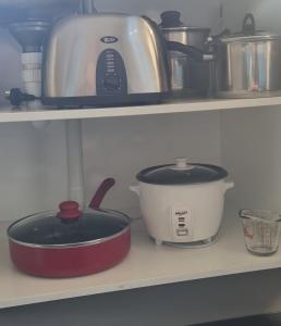 a kitchen shelf with two pots and a toaster at Star Cottages in Lake Tekapo +13 photos