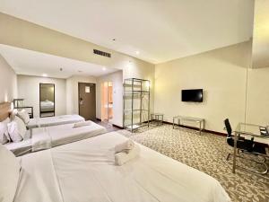 Postel nebo postele na pokoji v ubytování Kingston Hotel 10 - Bukit Jalil