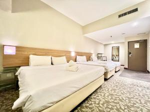 Postel nebo postele na pokoji v ubytování Kingston Hotel 10 - Bukit Jalil