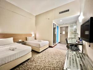 Postel nebo postele na pokoji v ubytování Kingston Hotel 10 - Bukit Jalil