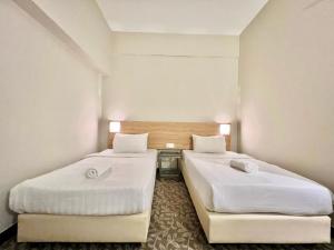Postel nebo postele na pokoji v ubytování Kingston Hotel 10 - Bukit Jalil