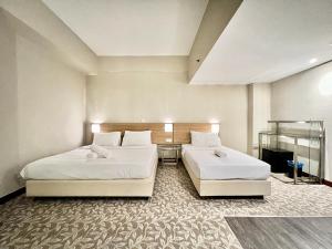 Postel nebo postele na pokoji v ubytování Kingston Hotel 10 - Bukit Jalil