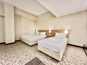 Postel nebo postele na pokoji v ubytování Kingston Hotel 10 - Bukit Jalil