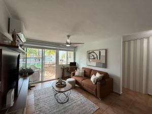 a living room with a couch and a table at Caribbean Zen at Bosque Del Mar - Las Picuas - Rio Grande in Rio Grande