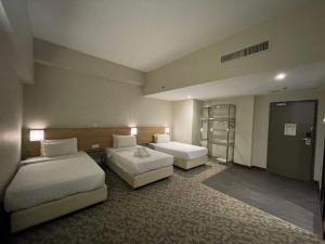 Postel nebo postele na pokoji v ubytování Kingston Hotel 10 - Bukit Jalil