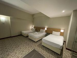 Postel nebo postele na pokoji v ubytování Kingston Hotel 10 - Bukit Jalil